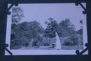 Old photo of a woman in a garden from the Kruse house collection